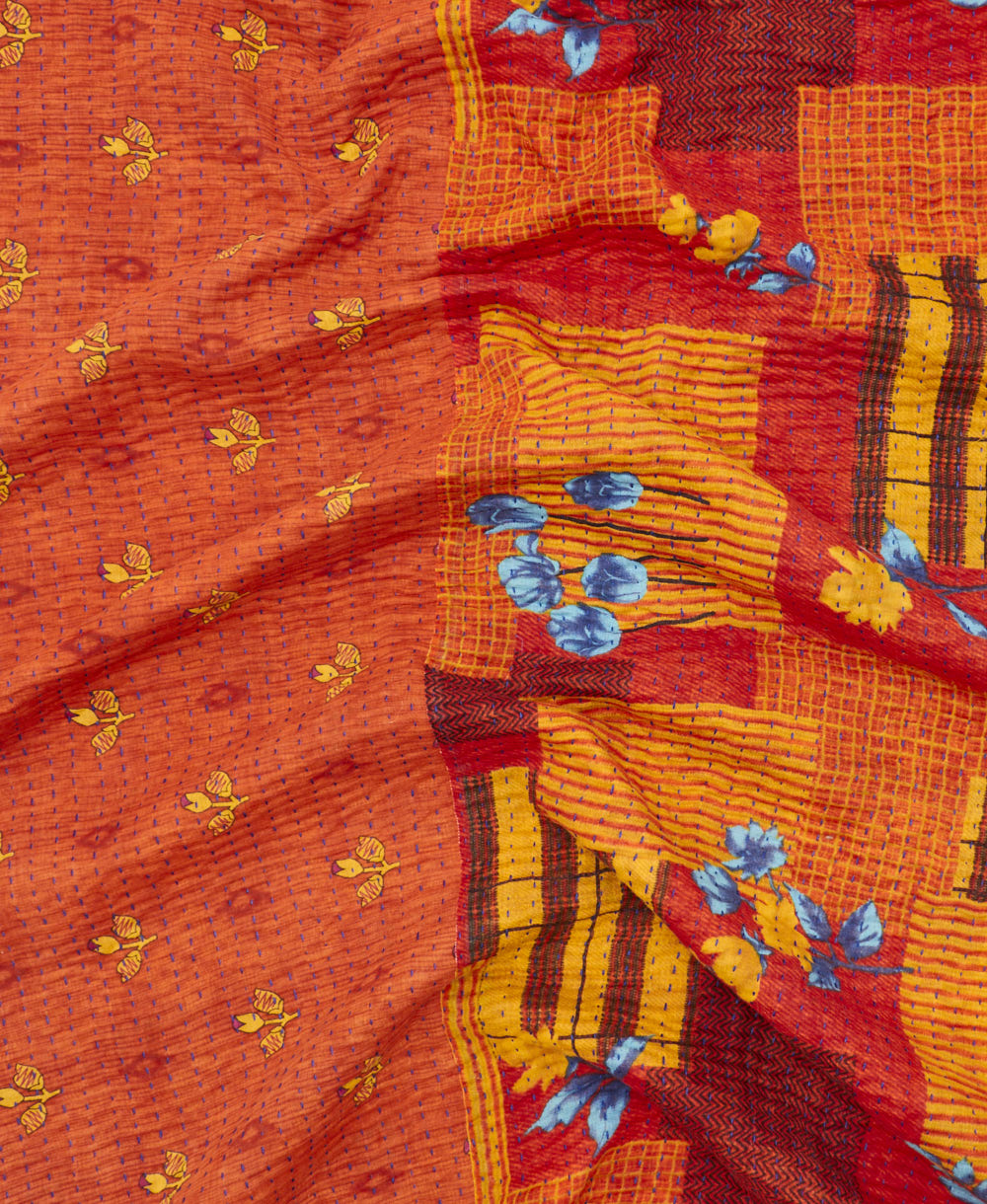 kantha quilt throw with a tag featuring the hand-stitched signature of the maker