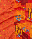 kantha quilt throw with a tag featuring the hand-stitched signature of the maker