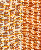 kantha quilt throw with a tag featuring the hand-stitched signature of the maker