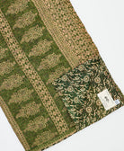 kantha quilt throw with a tag featuring the hand-stitched signature of the maker