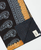 kantha quilt throw with a tag featuring the hand-stitched signature of the maker