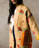 handmade yellow-beige quilted jacket with long open front and two front pockets by Anchal