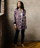 woman wearing cardigan style quilted jacket with open front in black and grey floral pattern