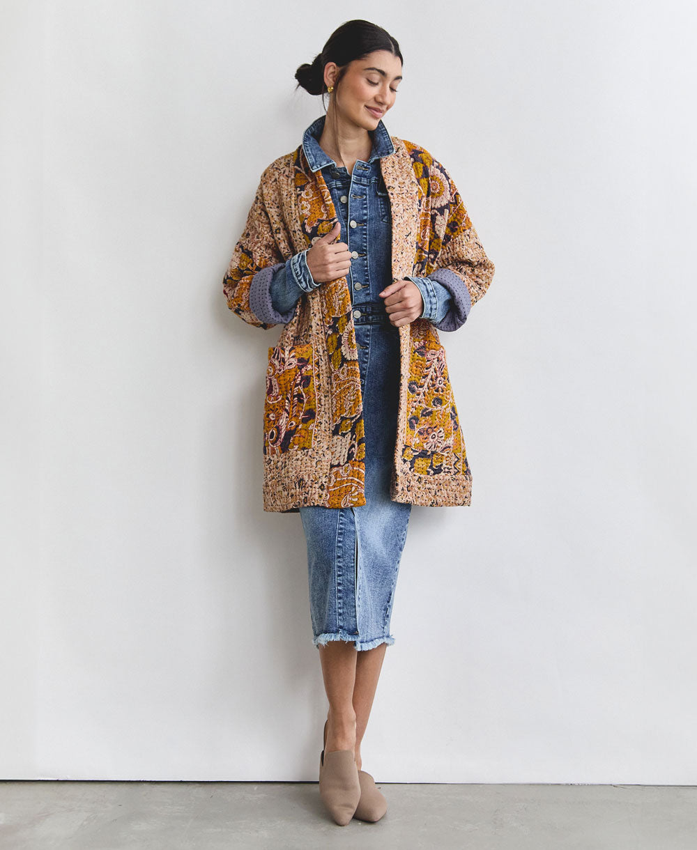 yellow and navy open front quilted jacket with hand-embroidery on woman wearing a denim dress