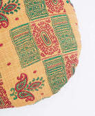 red and green geometric printed one-of-a-kind tan circle pillow handmade by women artisans