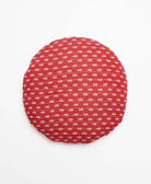 faded red round throw pillow with tan leaf pattern handmade in India by women artisans