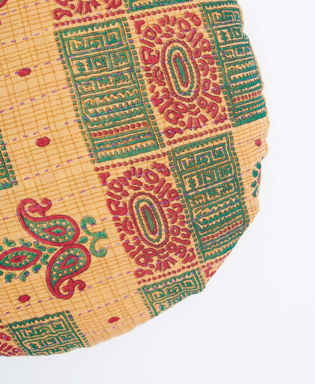 purple kantha stitching on tan circle pillow with gold-tone YKK zipper closure