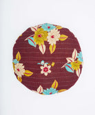 back of brown kantha round throw pillow with lime green and sky blue flowers