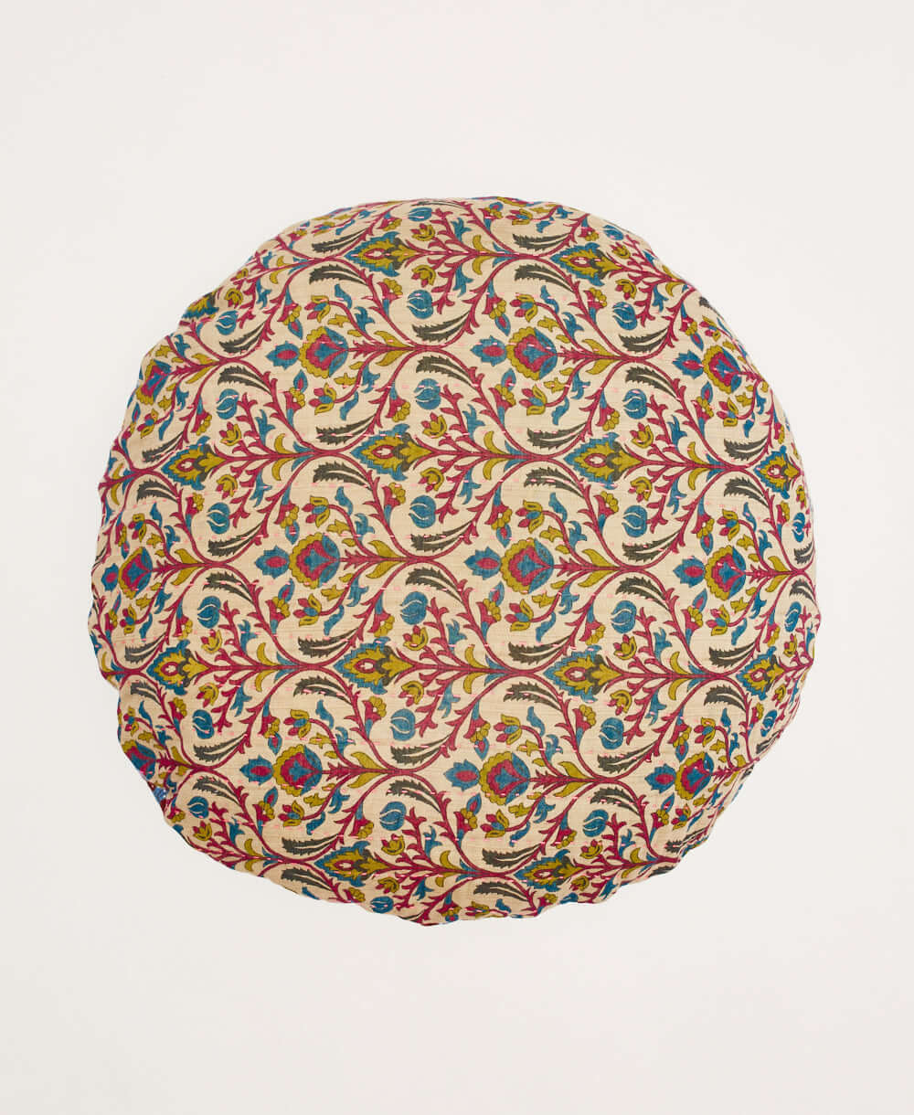 tan round pillow with lime green, magenta purple and cobalt blue floral vine pattern