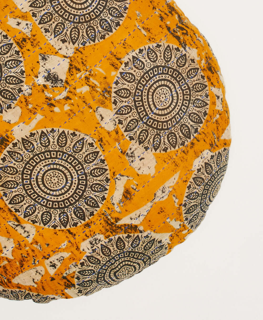 ky blue stitchiing embroidery detail on orange circle pillow made of upcycled vintage cotton saris