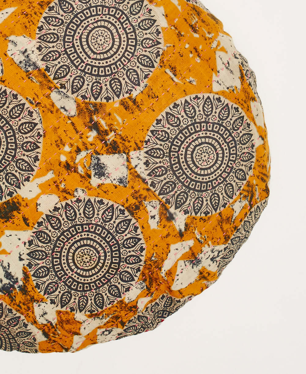 circle pillow in tangerine orange with light pink kantha embroidery with removable down feather insert