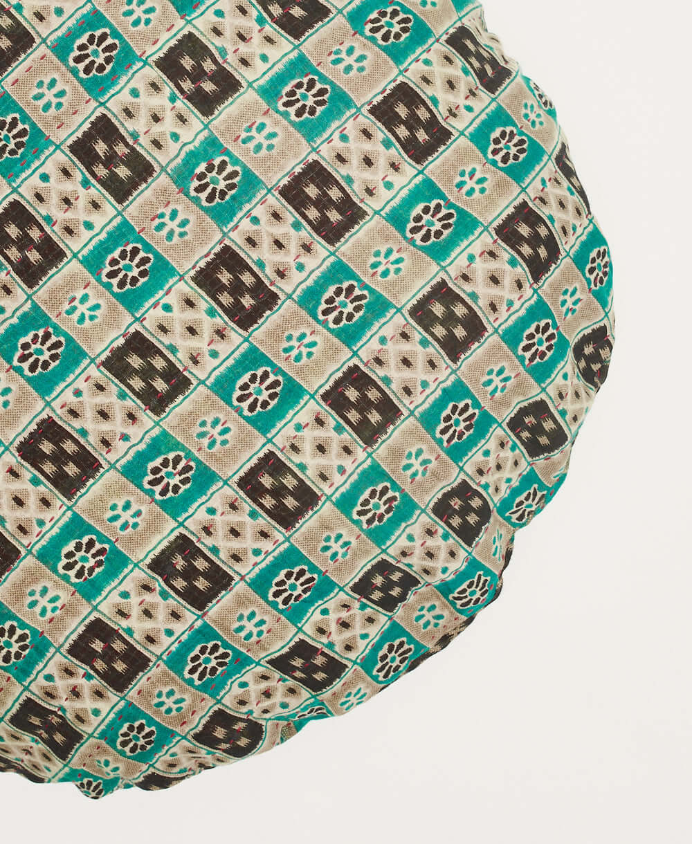 hand-embroidered circle pillow in teal and black checkered print made by women artisans in India