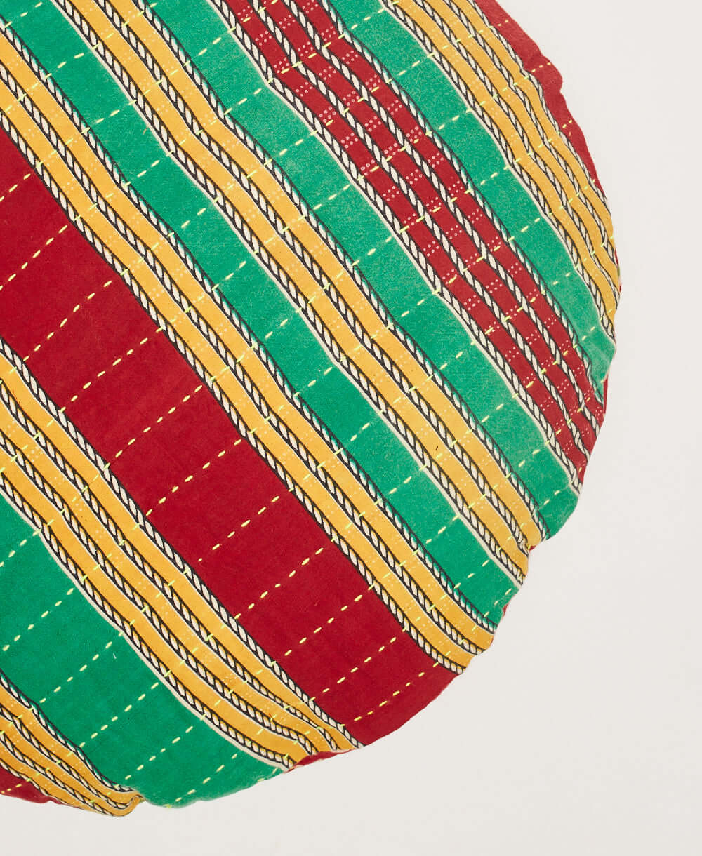 green, red and yellow striped circle pillow made in a Fair Trade environment in India