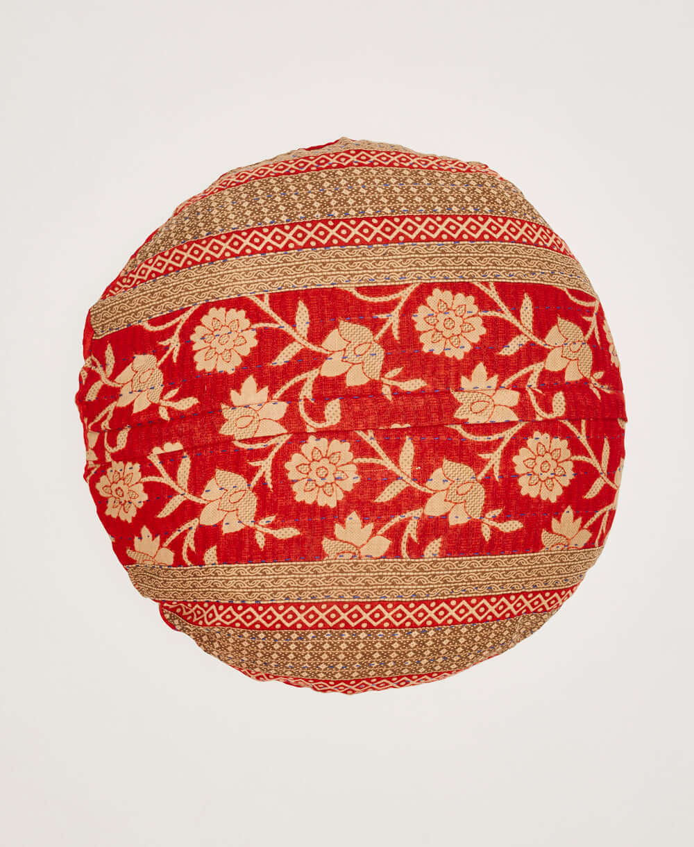 back of bright red circle pillow with tan floral design & stripes