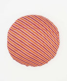 round pillow featuring a brufundy and orsnge stripe pattern 