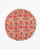 artisan made round pillow featuring a red and orange pattern 