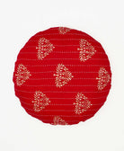 round pillow featuring a red and green tree print made by women