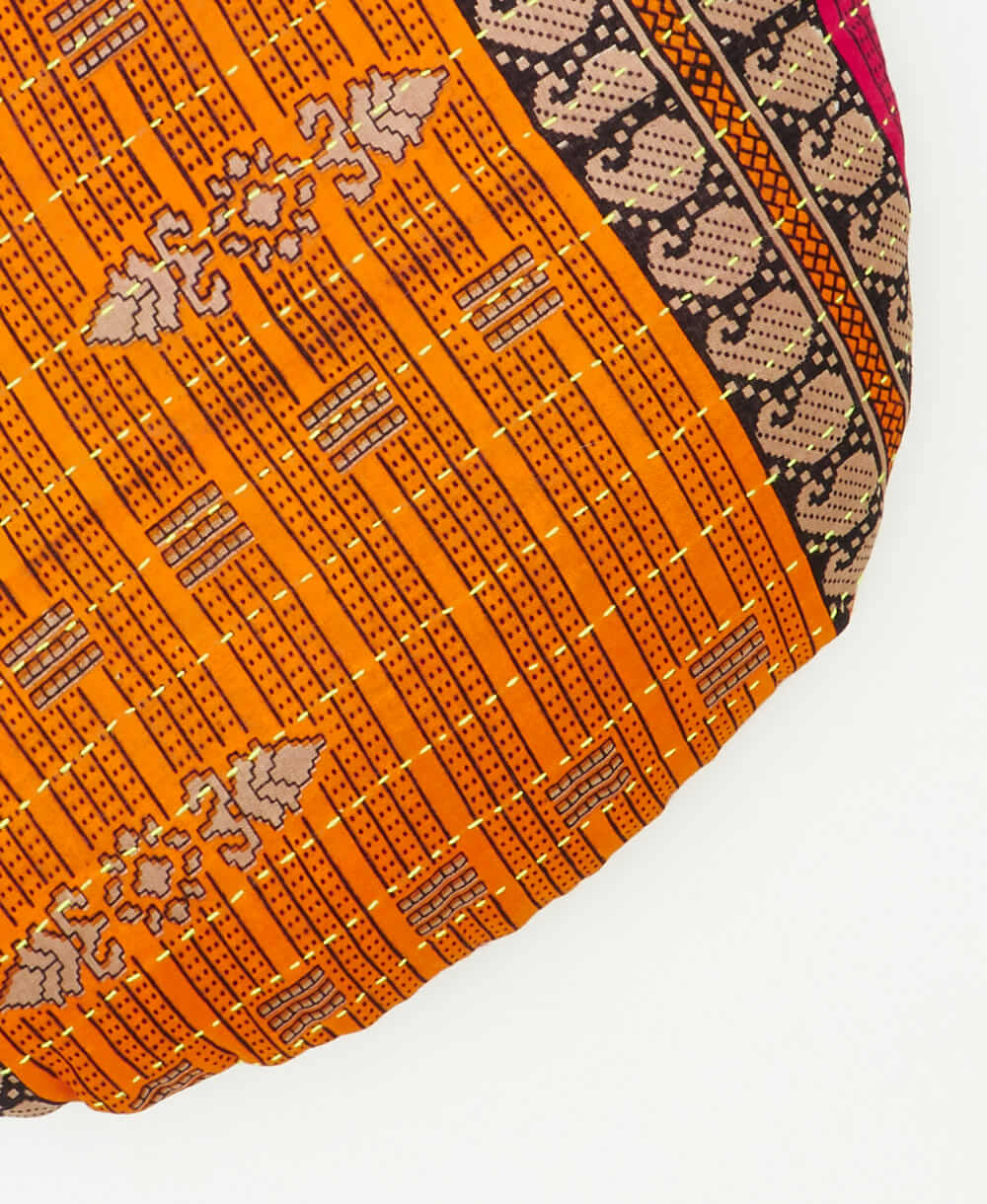 circle pillow featuring red traditional kantha hand stitching 