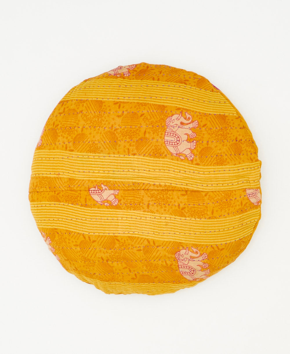 round pillow crafted from repurposed yellow saris 