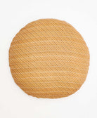 tan round pillow with delicate black diamond details 