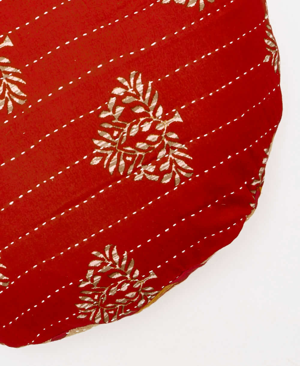 one-of-a-kind red botanical circle pillow with white embroidery 