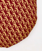 dark red and yellow geometric circle pillow with white embroidery 