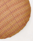 red and tan paisley circle pillow with yellow embroidery 