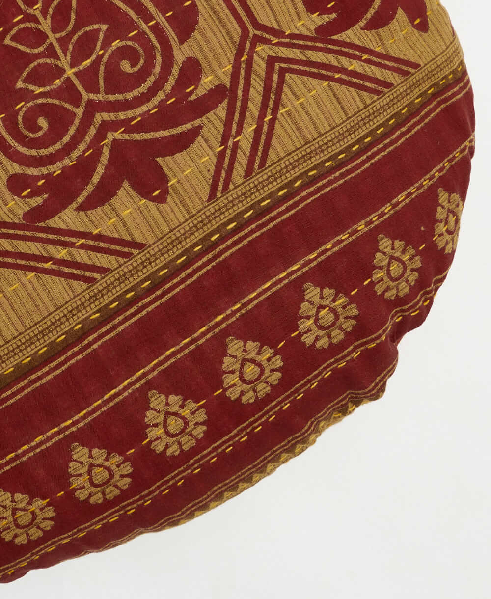 brown and red paisley circle pillow with kantha stitching 