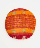 red and orange striped round pillow with handstitched details 