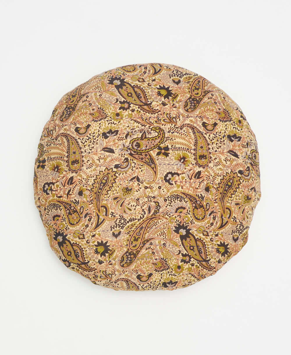 neutral paisley round pillow with blakc, green, and pink details 