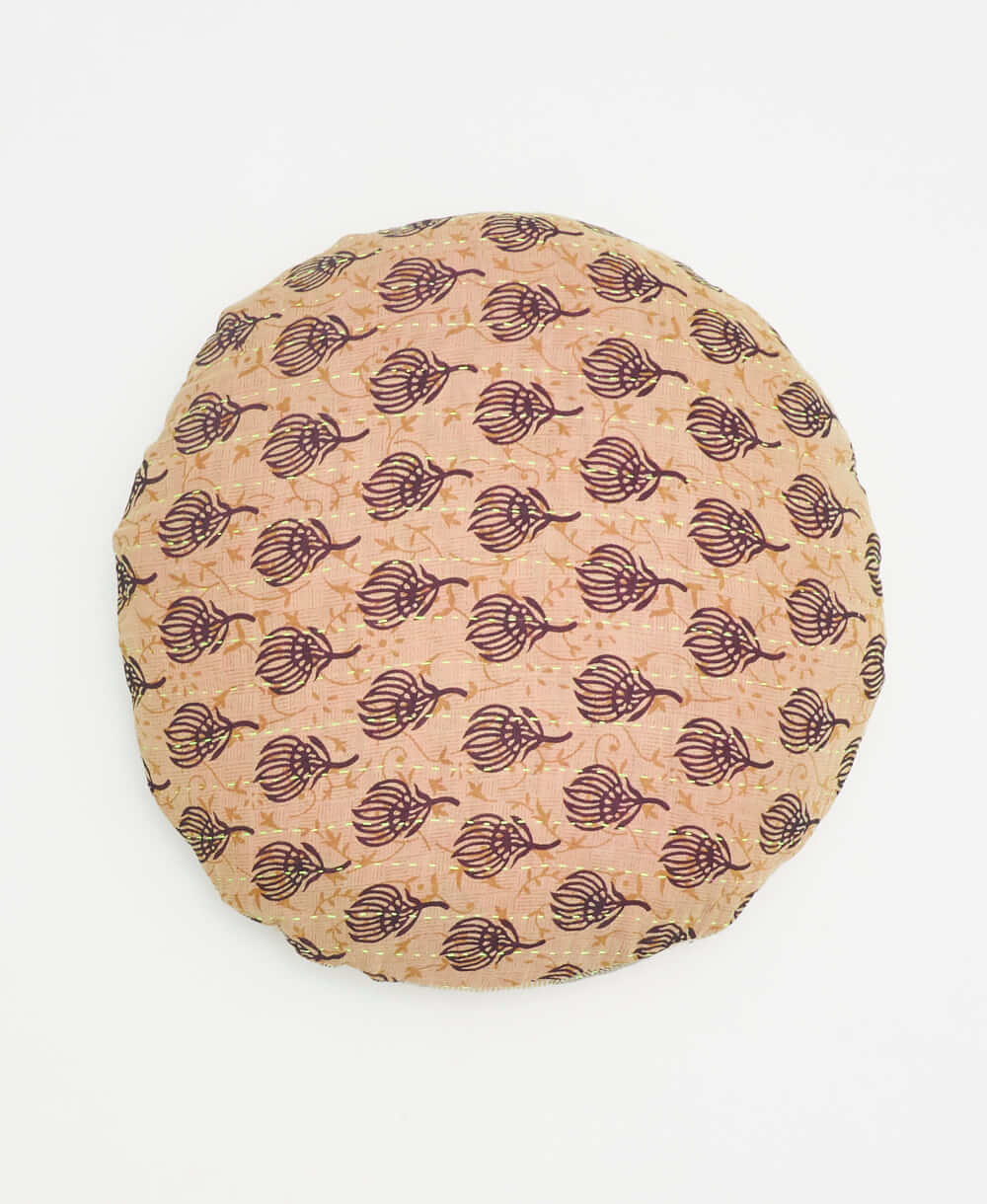 tan handmade round pillow with a black botanical print