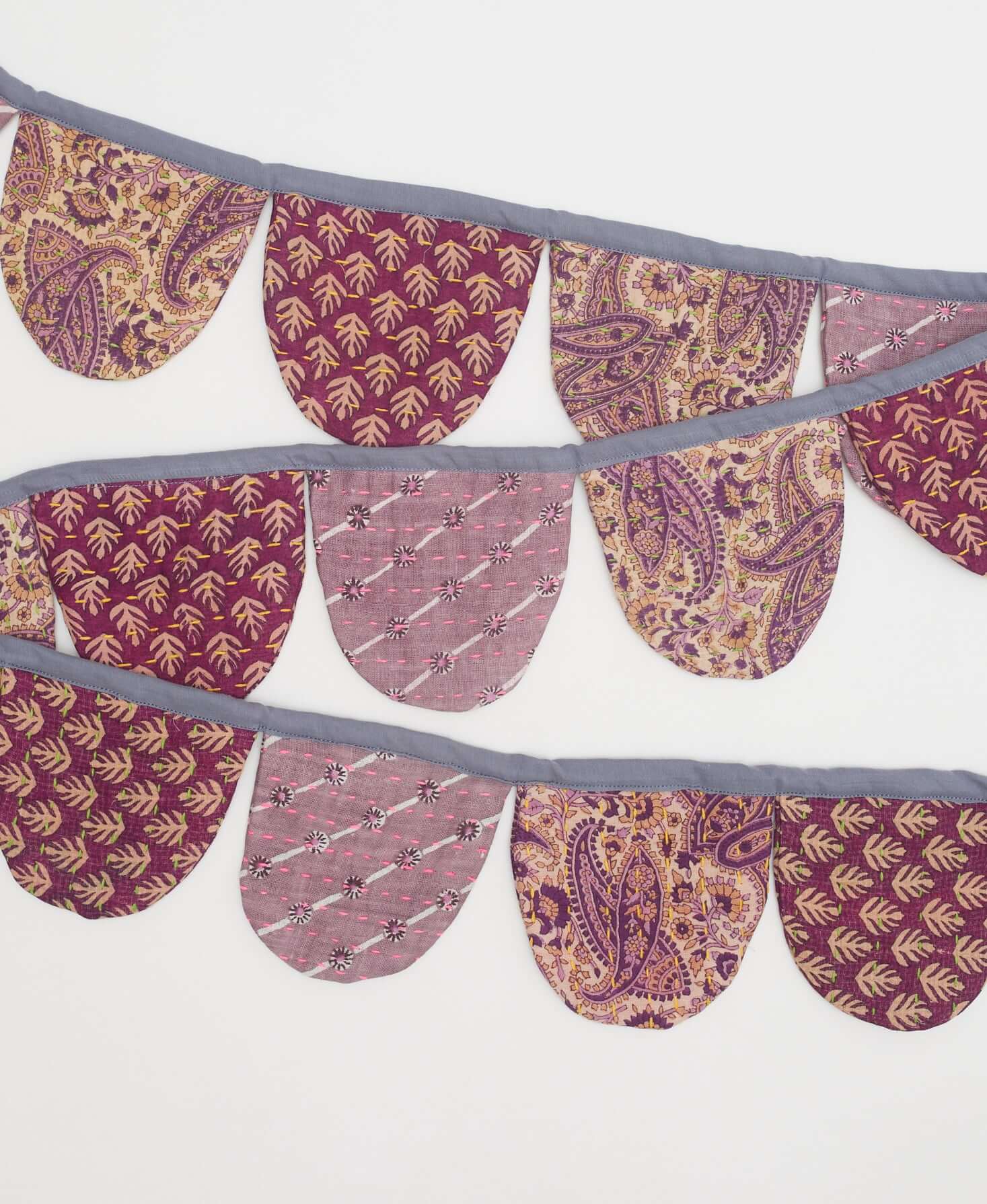 eco-friendly bunting handmade by women artisans using scraps of recycled vintage cotton saris with traditional kantha stitching