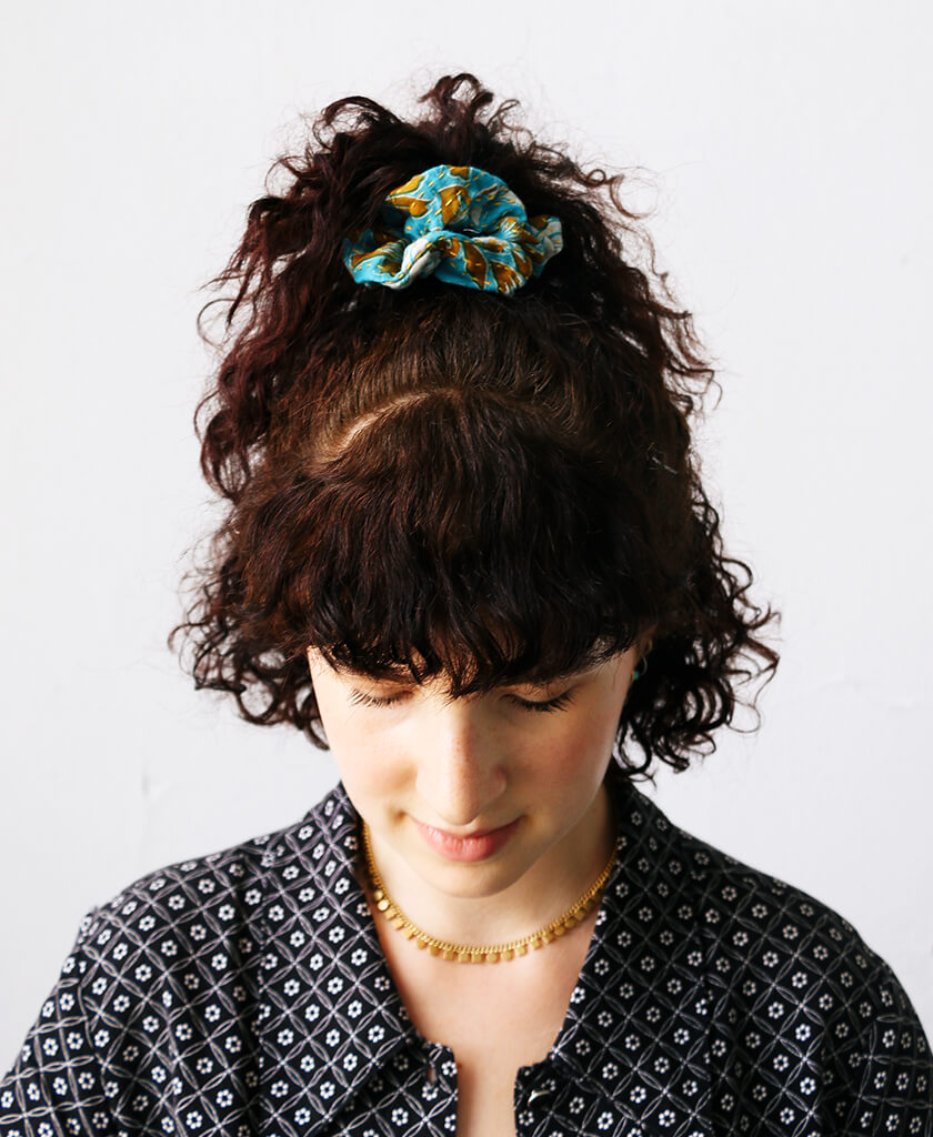 colorful blue cotton kantha scrunchie by Anchal on model with dark curly hair