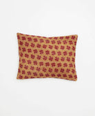 small lumbar pillow in warm tan with red daisy pattern