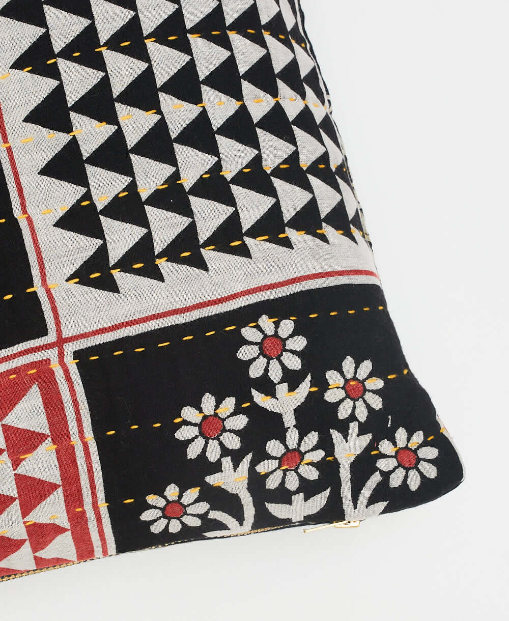 yellow kantha embroidery on small throw pillow in black and grey arrow design with red floral accents