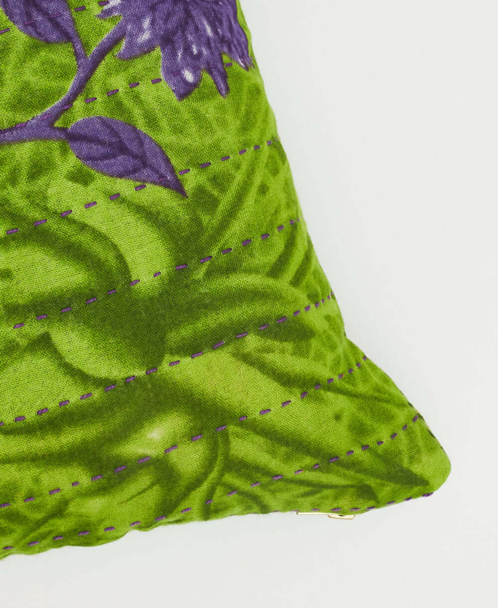 small throw pillow with purple kantha embroidery on bold lime green pattern