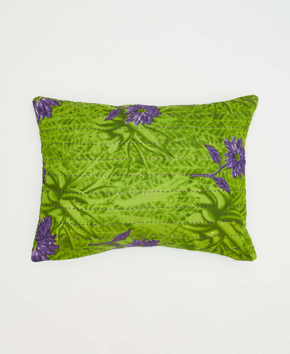 lime green small pillow with graphic purple daisies printed on front