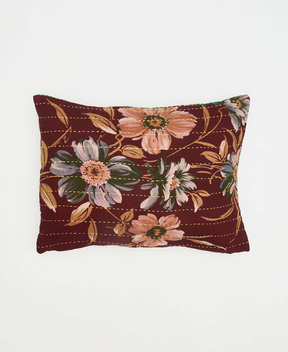 small pillow made from vintage fabrics with a bold brown & tan floral design with green accents