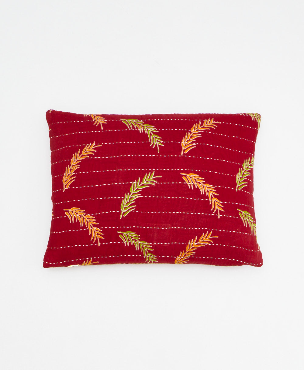 small lumbar pillow in bright red with orange & lime leaf print with removeable down feather insert