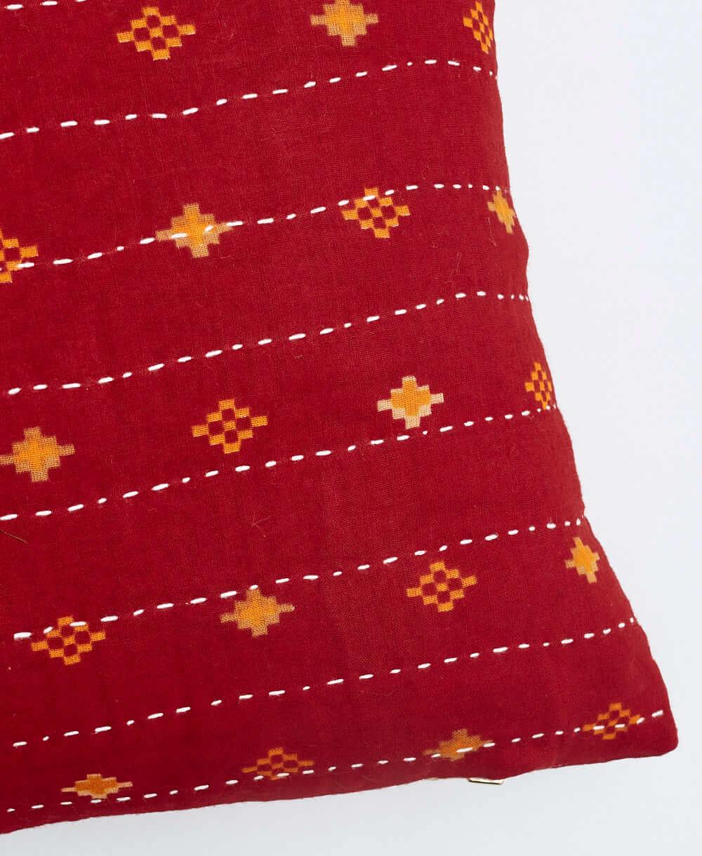 white kantha embroidery on bright red small throw pillow with orange diamond print