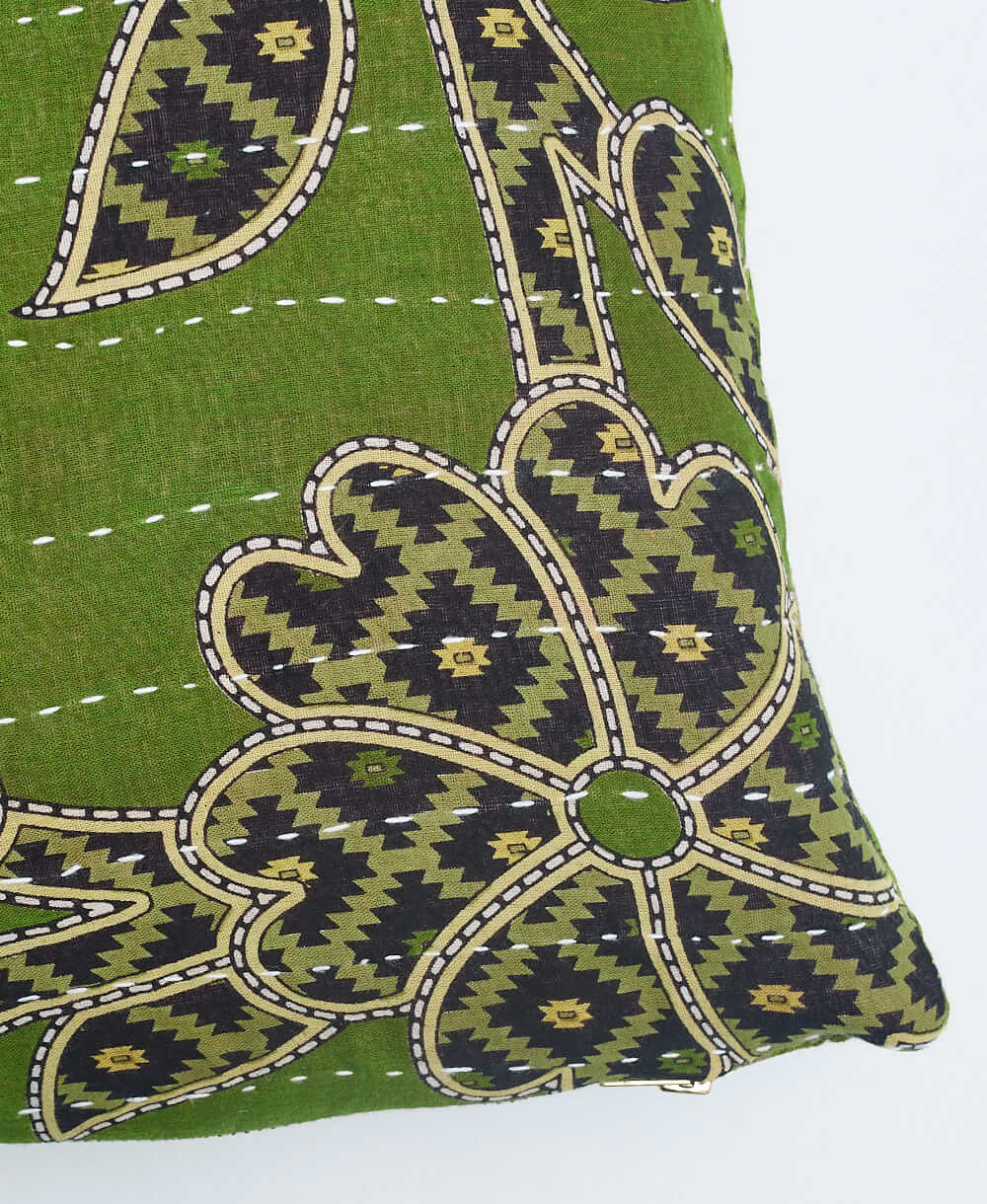 white kantha embroidery on olive green small throw pillow with black floral print