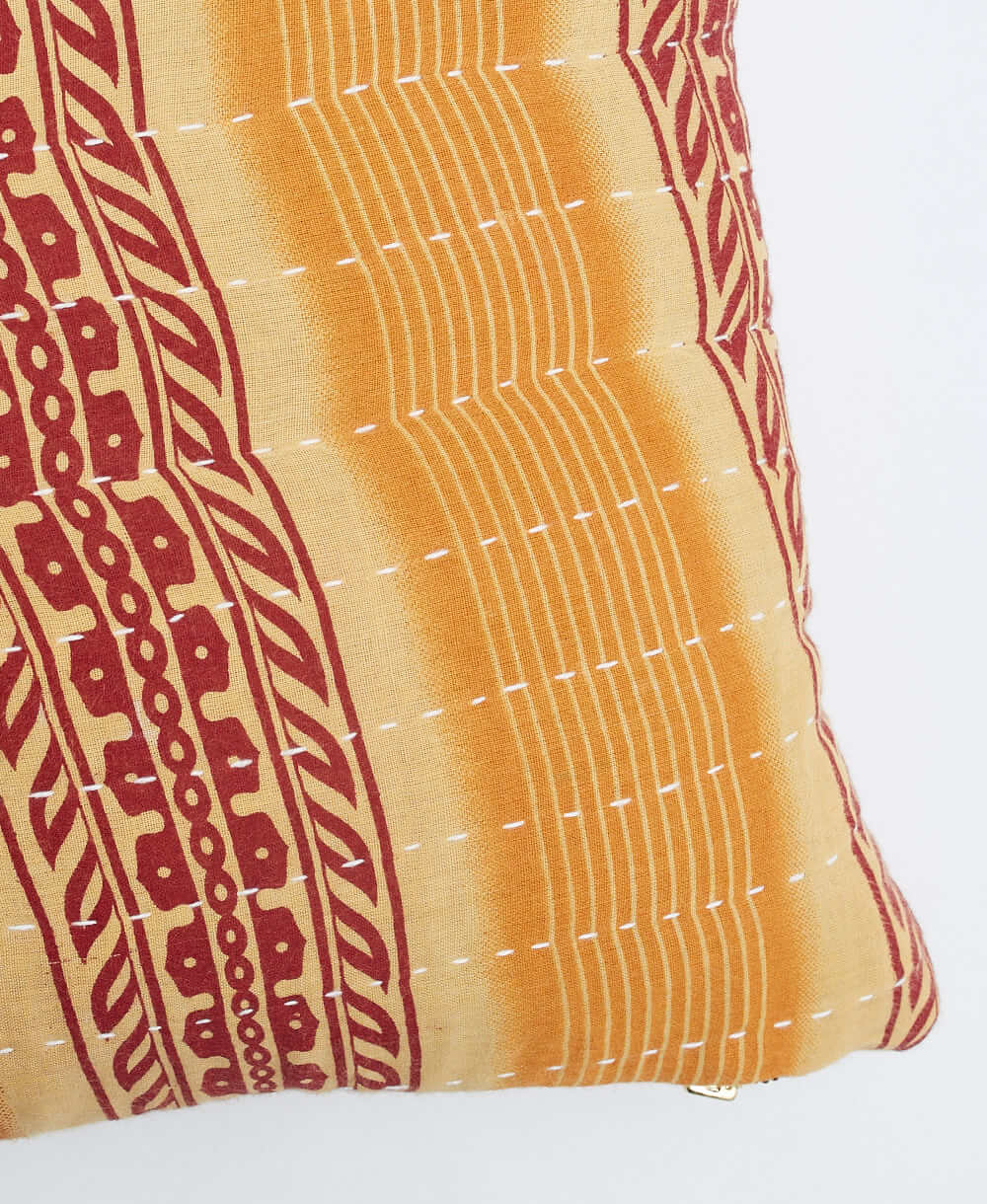 white kantha embroidery on sandy beige small throw pillow with red & yellow stripes print