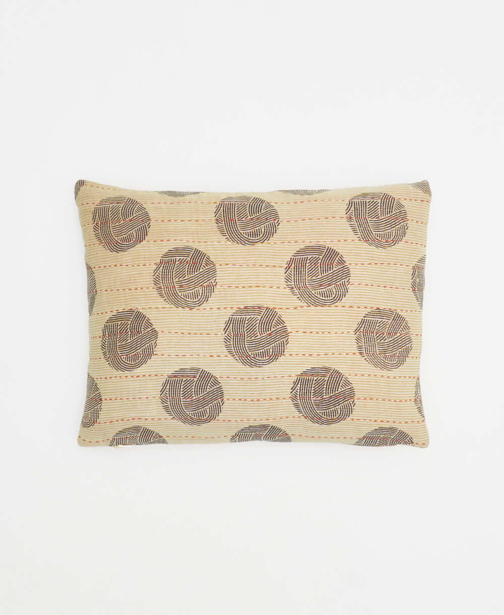 small lumbar pillow in sand with black circular print with removeable down feather insert