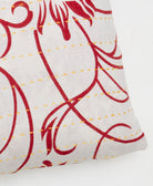 yellow kantha embroidery on ivory small throw pillow with a red chevron print