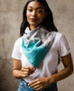 woman in a white t-shirt and jeans wearing an Anchal vintage cotton square scarf tied around her neck