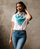 sky blue traditional cotton square scarf tied around womans neck wearing a white t-shirt and denim