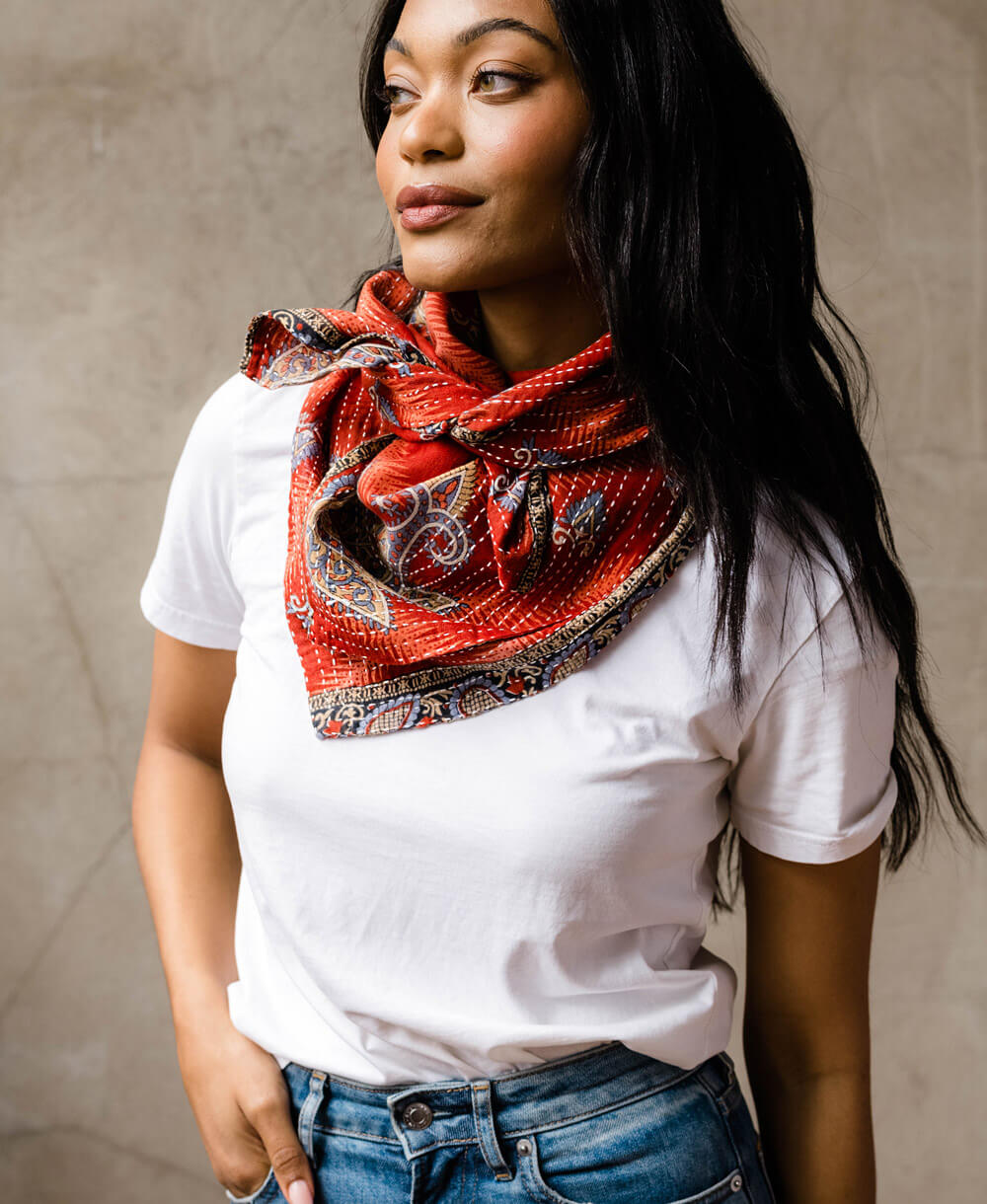 woman wearing rust colored cotton oversized square scarf styled around her neck and tied