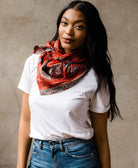 rust red ethically made cotton square scarf wrapped around womans neck wearing a white t-shirt