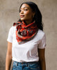 woman in white t-shirt and jeans wearing an anchal vintage kantha square scarf tied around her neck