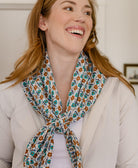 sustainably made cotton square scarf in white with coral and teal small flowers